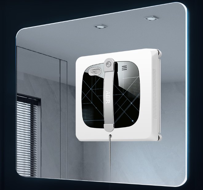 Window washing robot on a large mirror, front view
